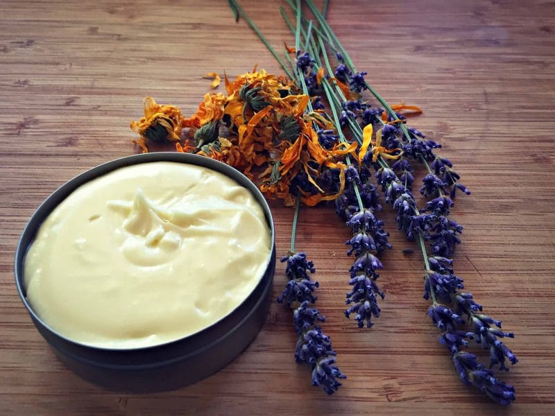 calendula cream on a board with flowers