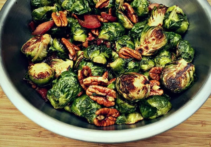 roasted brussels sprouts with bacon and maple pecans in a bowl