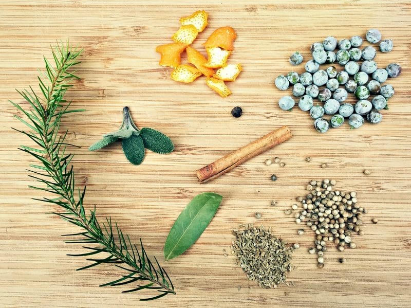 winter infused gin botanical ingredients on a cutting board