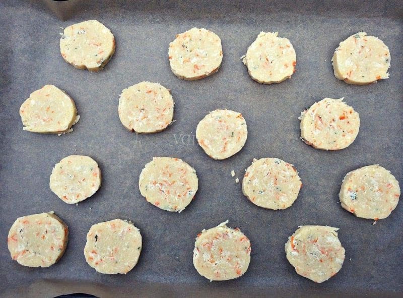 unbaked calendula shortbread cookies on parchment lined baking sheet