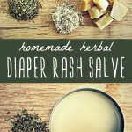 A tin of herbal diaper rash salve with fresh herbs.