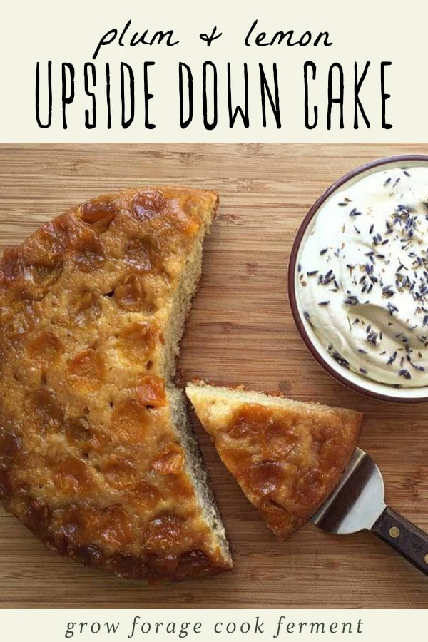 Plum and lavender upside down cake on a wood cutting board with a side bowl of lavender whipped cream.