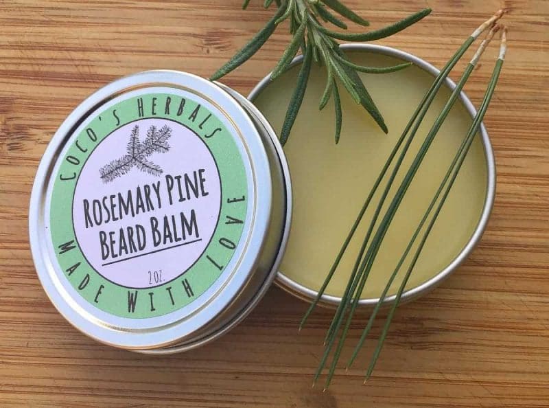rosemary pine beard balm in a tin with a label