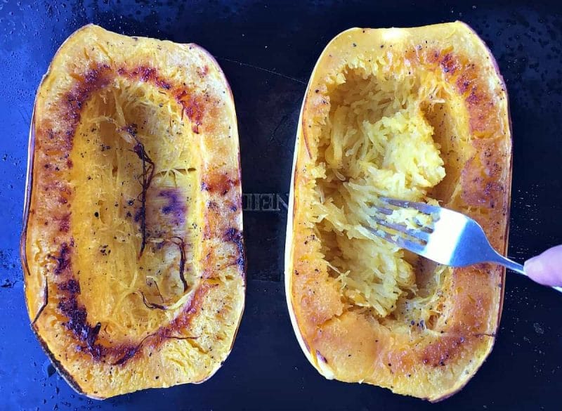 scooping out spaghetti squash strands with a fork