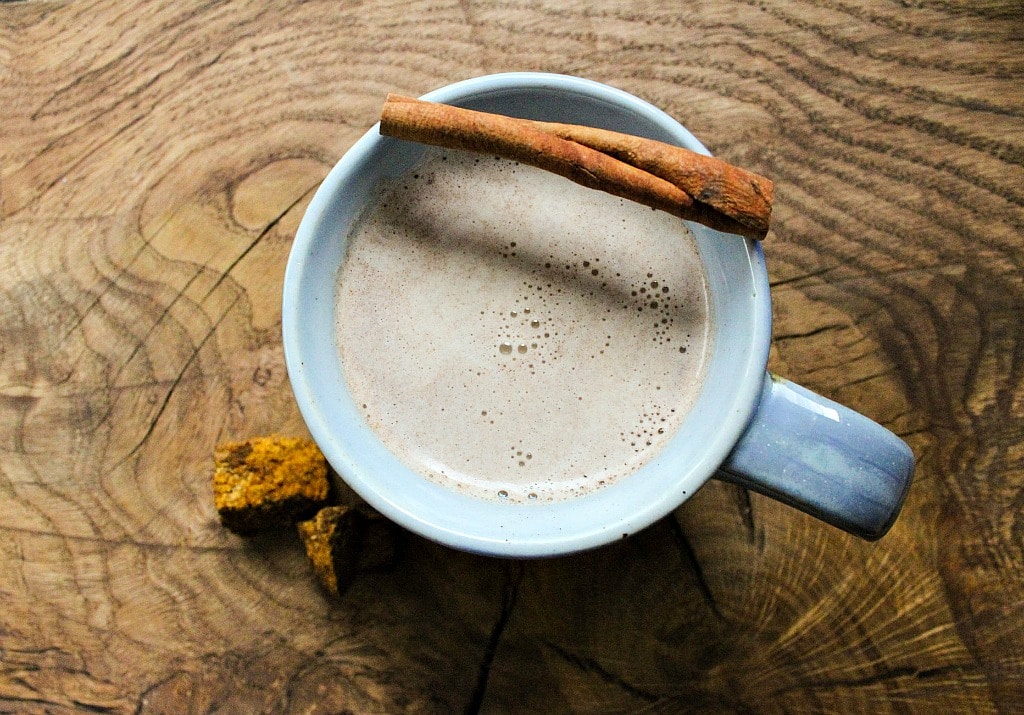 a mug of chaga chai with a cinnamon stick