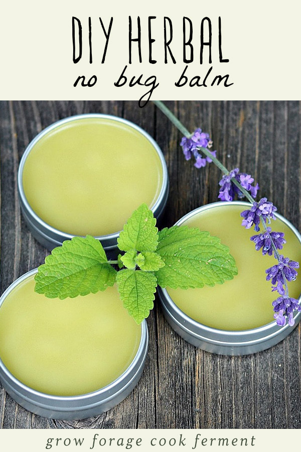 Three tins of diy herbal no bug balm on a wood table.