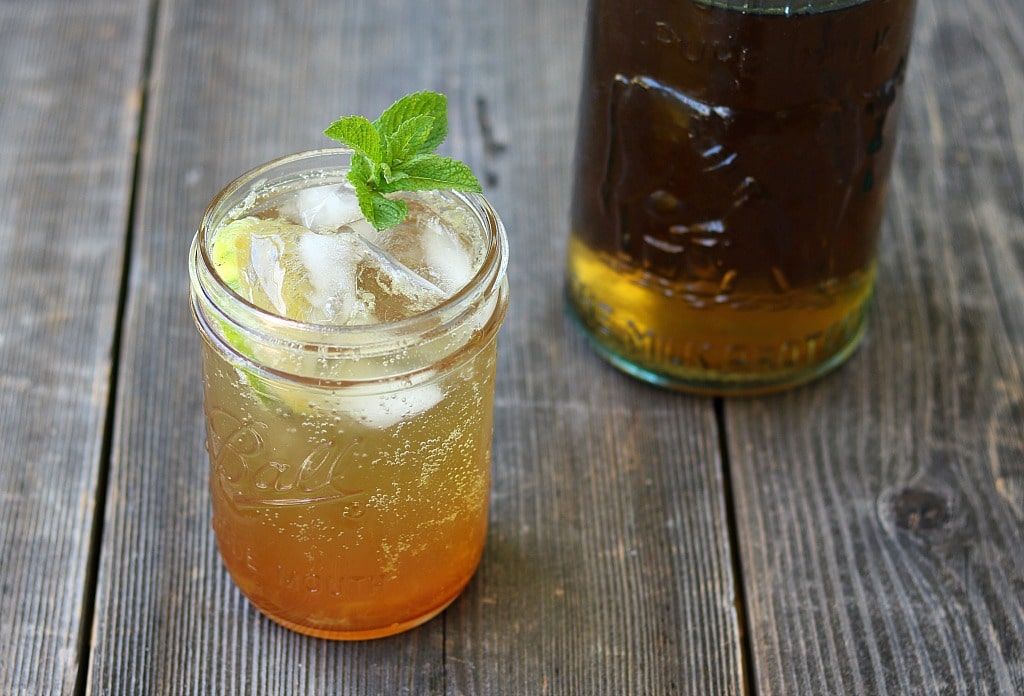 a glass of stinging nettle ade garnished with mint