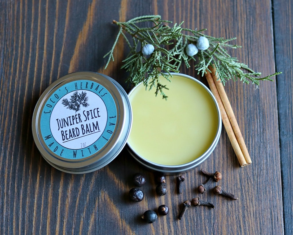 juniper spice bearm balm in a tin with a label