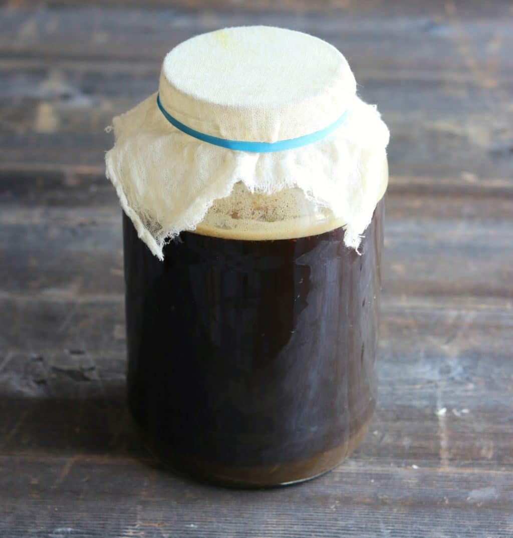 fermenting the root beer in a one gallon wide mouth jar with cheesecloth