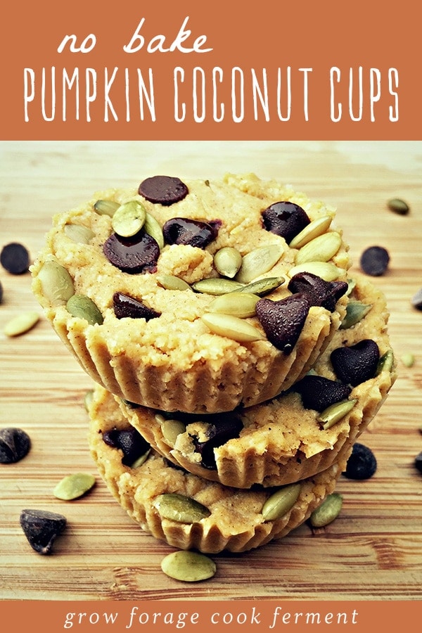 A stack of no bake pumpkin coconut cups on a wood cutting board.