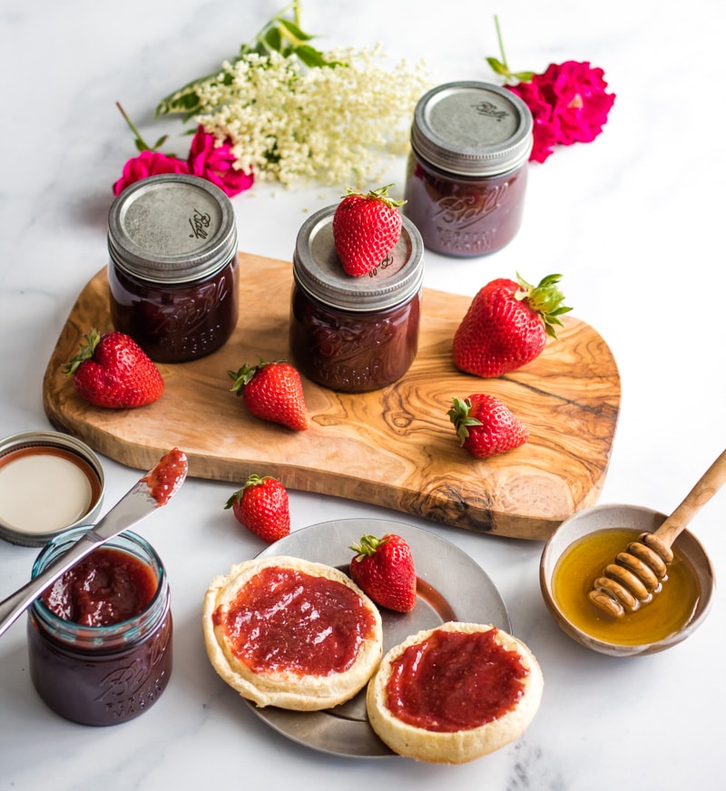 a breakfast scene with jars of strawberry butter