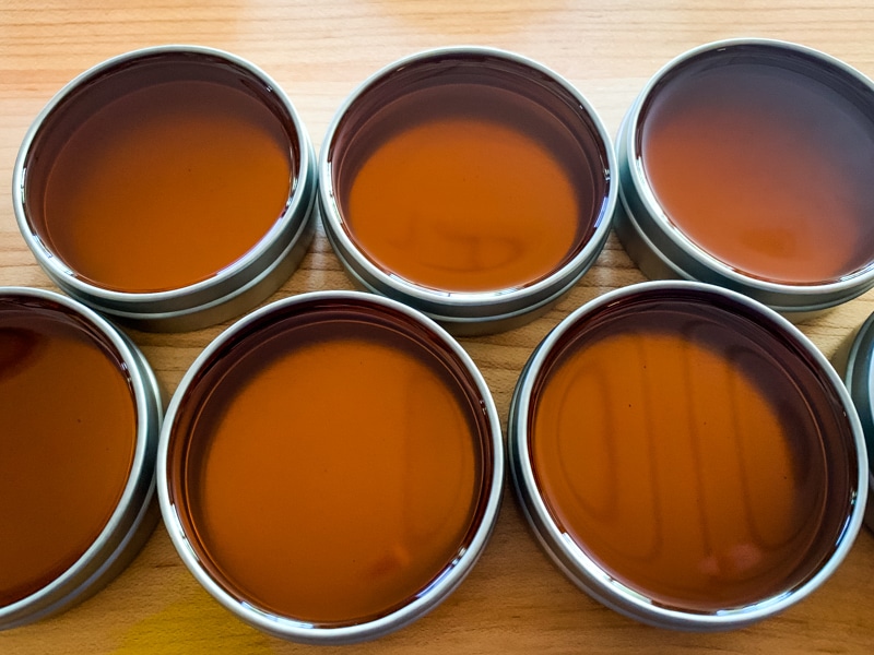 freshly poured st. john's wort salve in tins