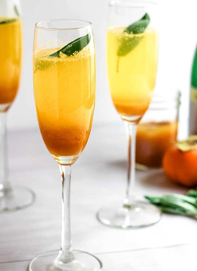 persimmon cocktail in champagne glasses