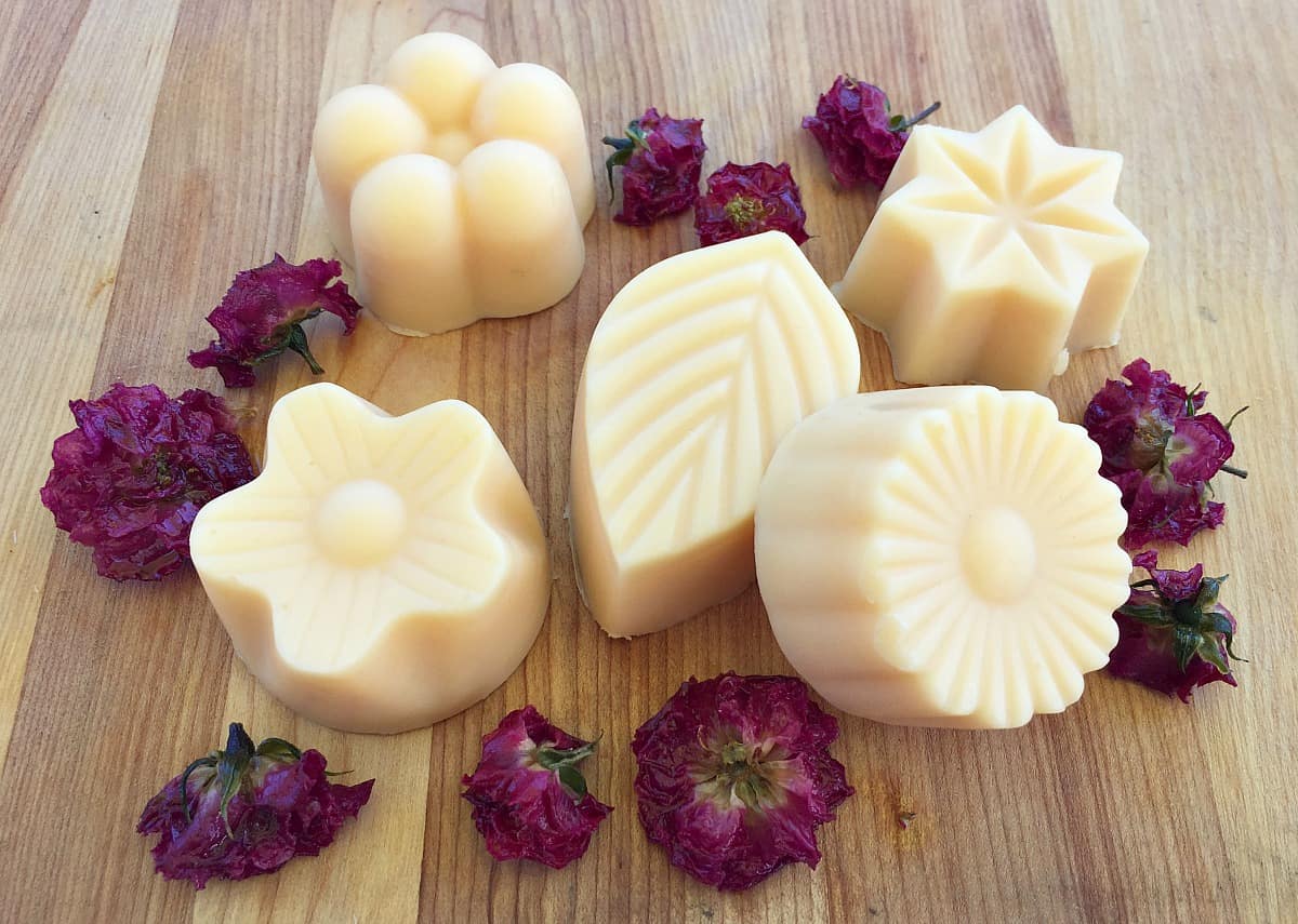 rose lotion bars on a wooden board