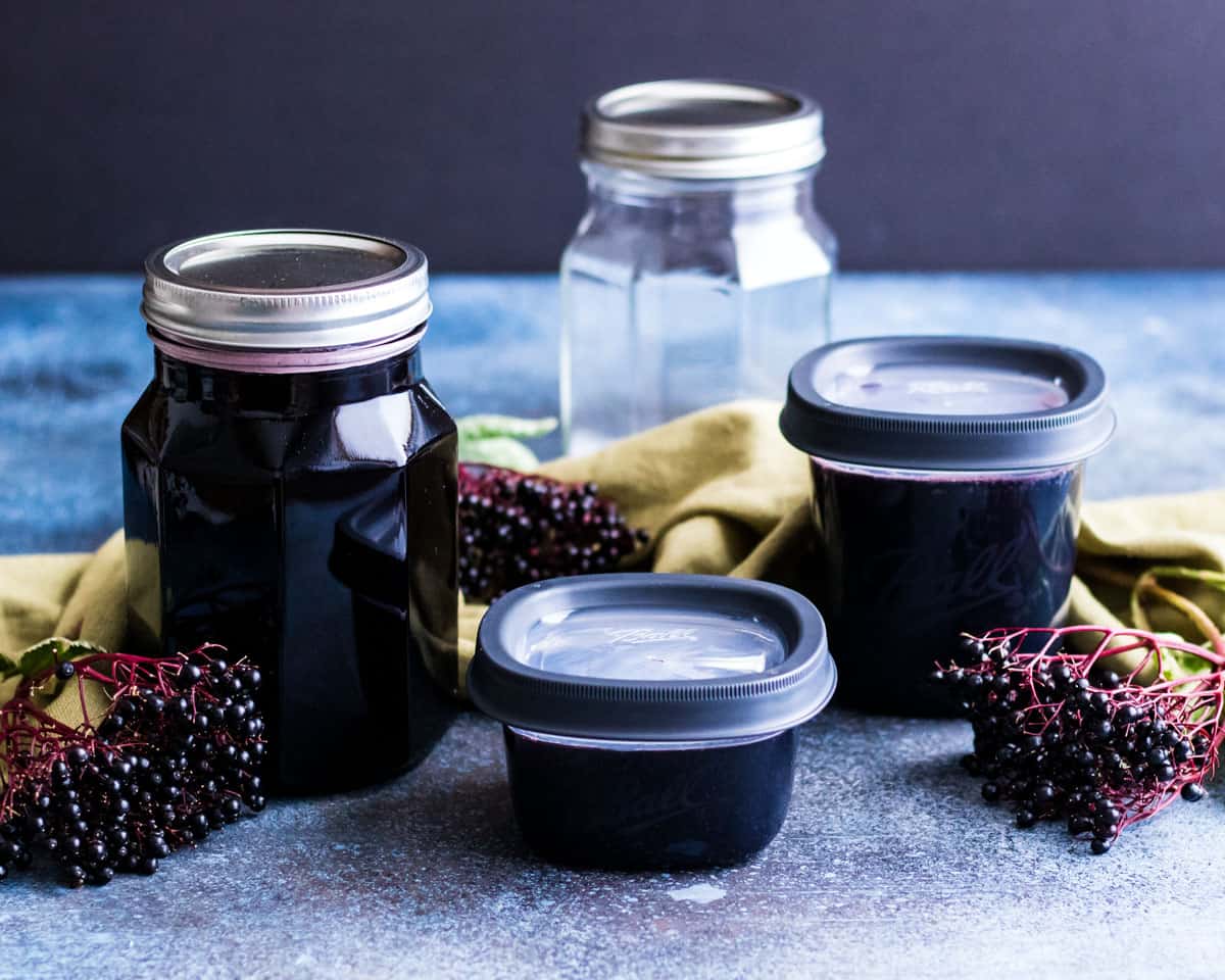 a jar and freezer jars of elderberry sryup