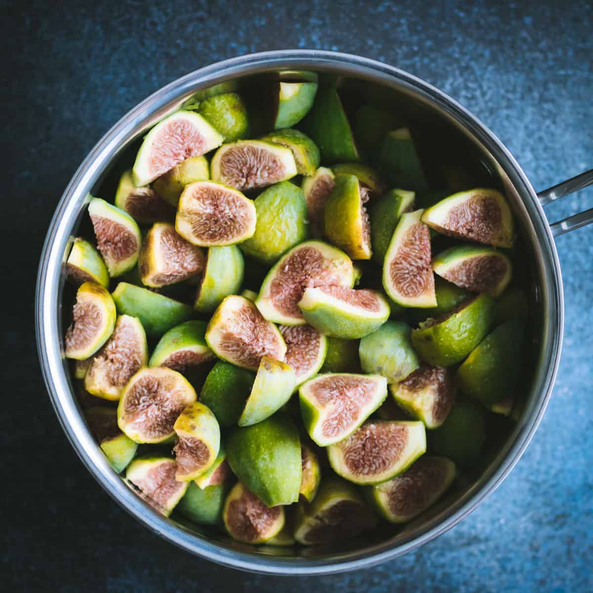 cut green figs in a pot