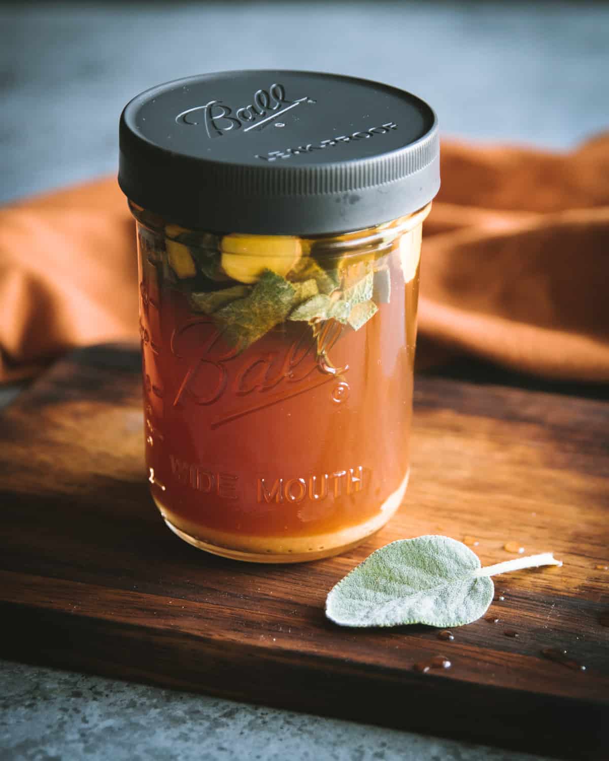 a ball jar with sage and ginger oxymel and a leak proof lid