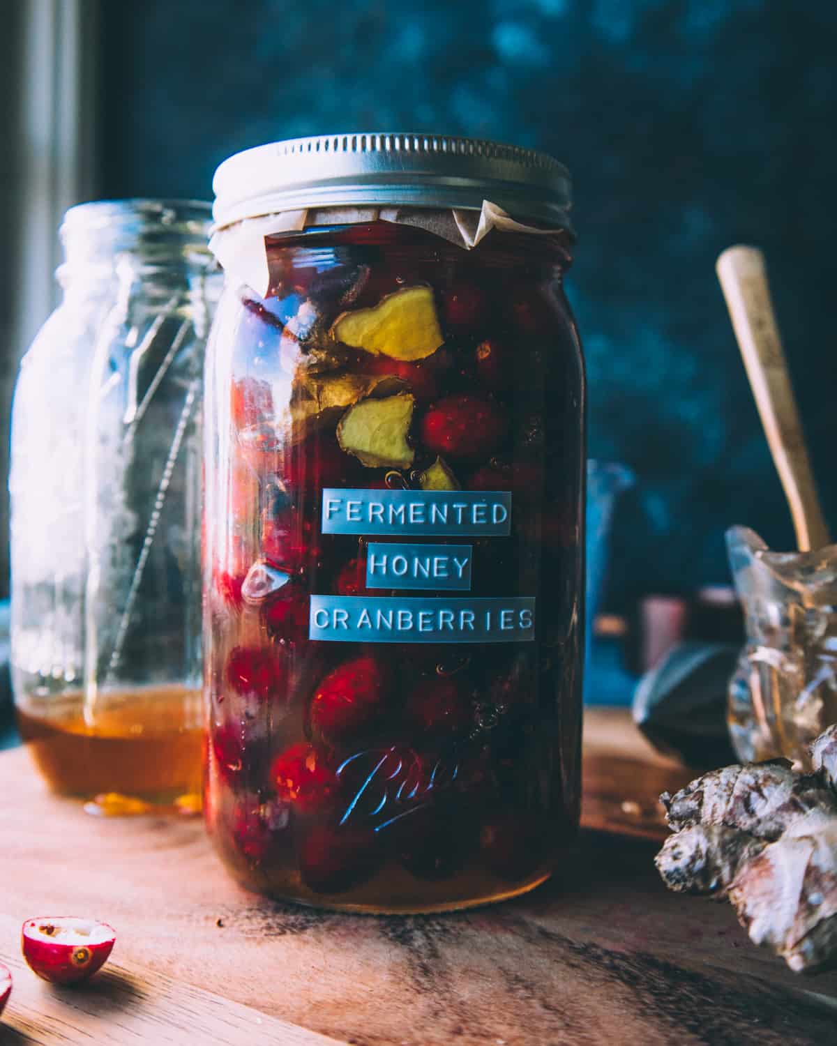 fermented honey cranberries in a quart jar with a lid