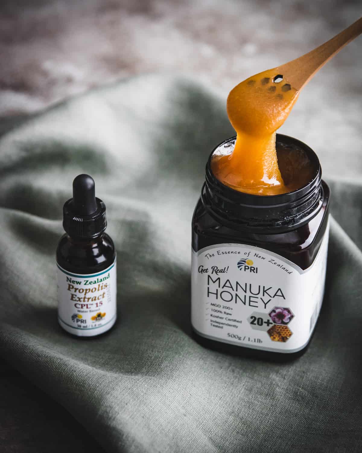 a bottle of propolis extract and a jar of manuka honey from PRI