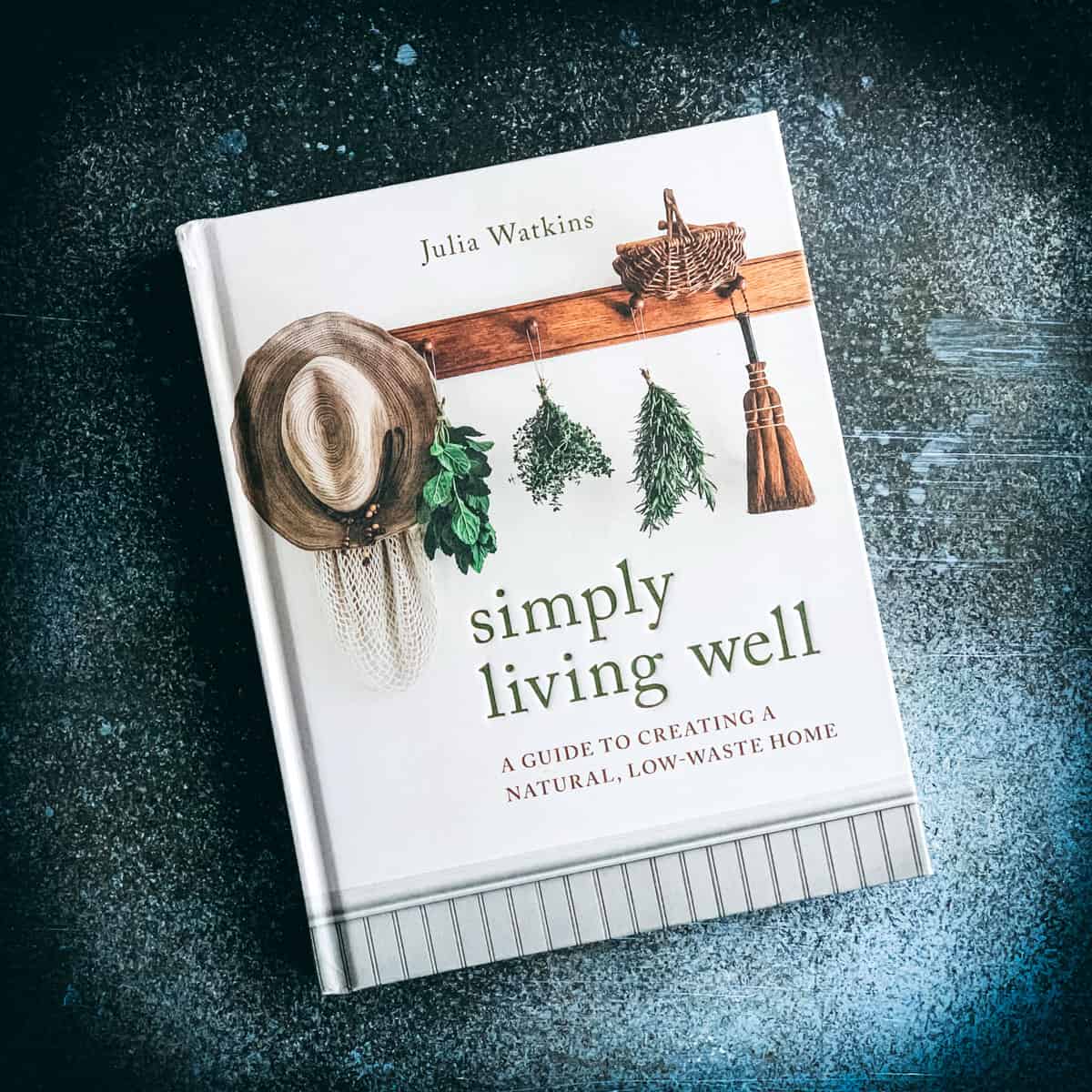 simply living well book by julia watkins on a dark blue background
