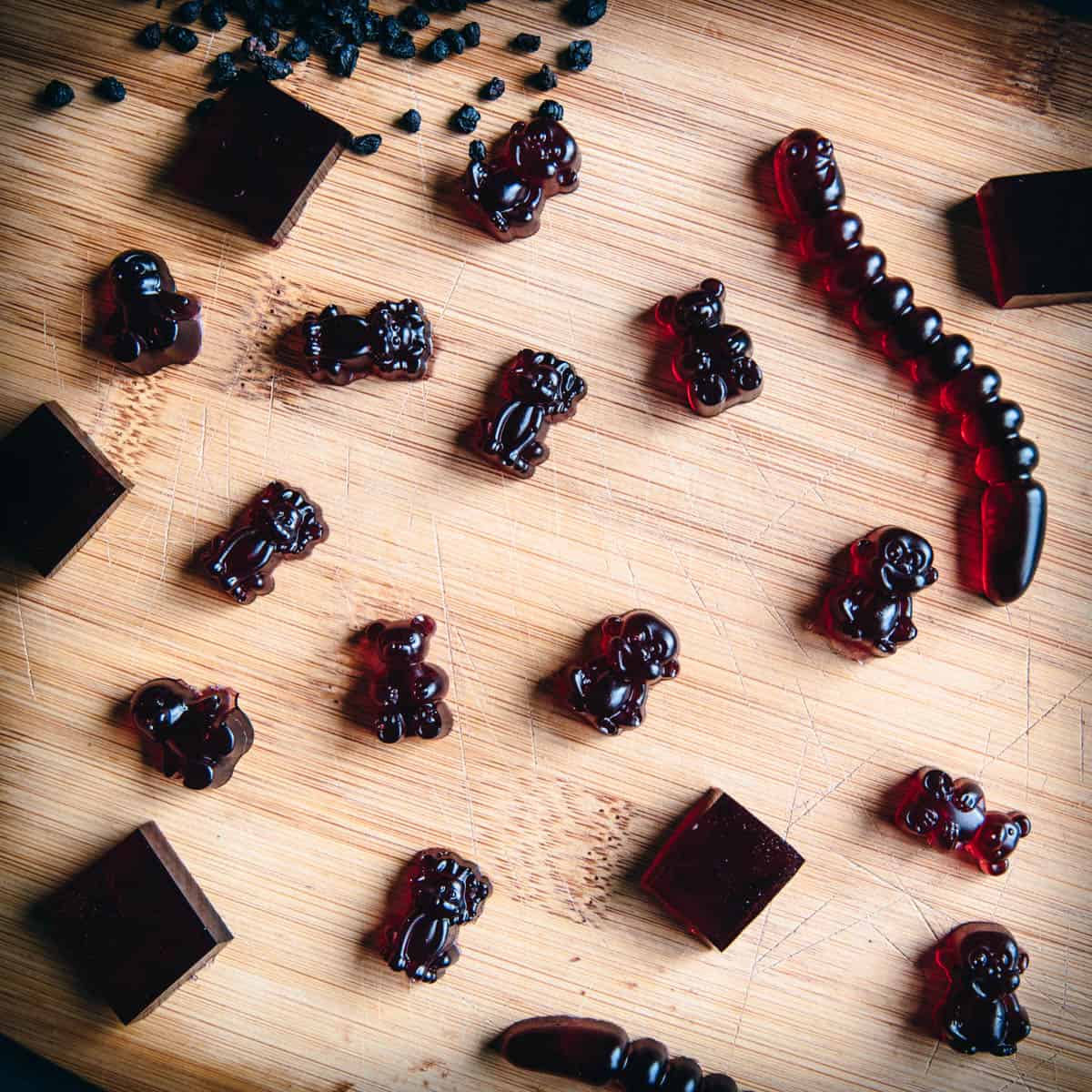 close up of elderberry gummies on a wooden cutting