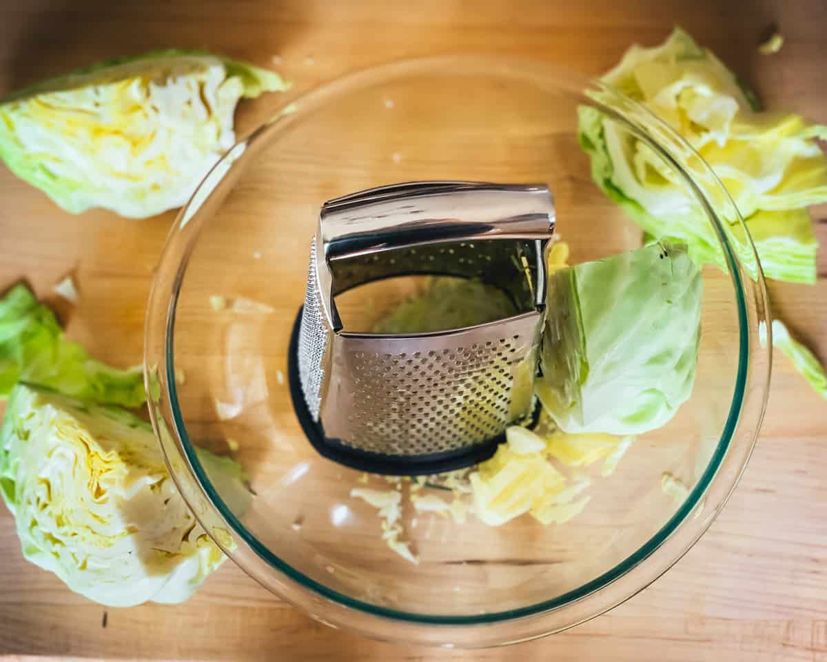 shredding the cabbage with a cheese grater