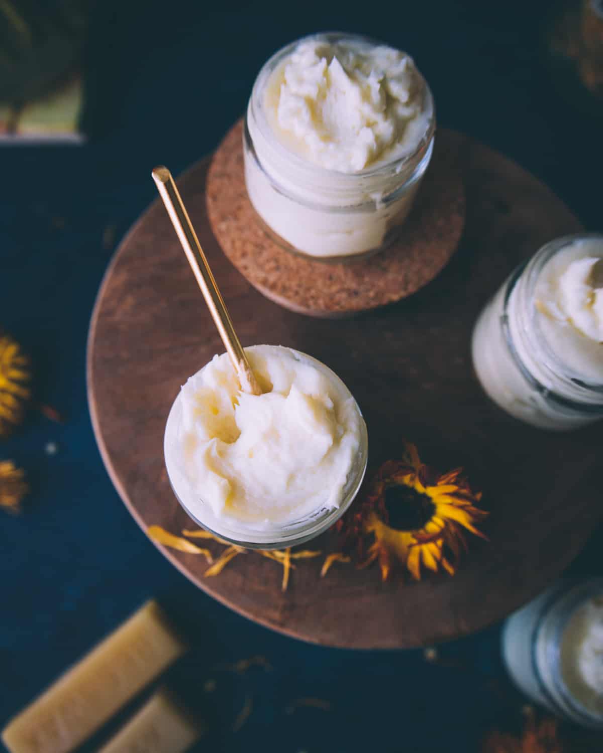 glass jars of calendula cream on a table