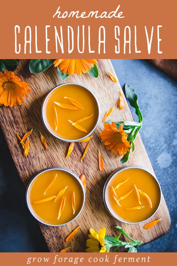 three tins of homemade calendula salve with calendula petals