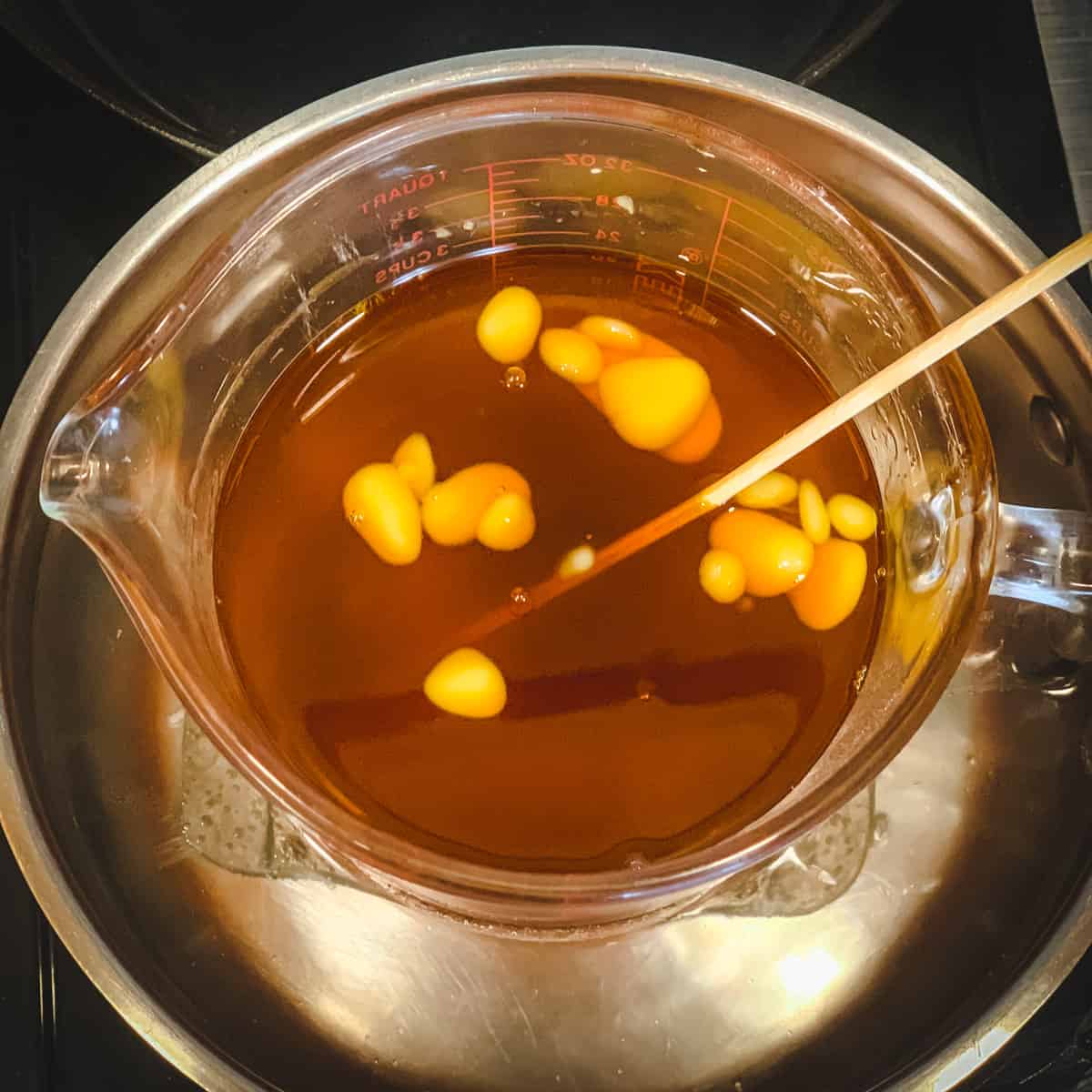 melting the beeswax into the calendula infused oil