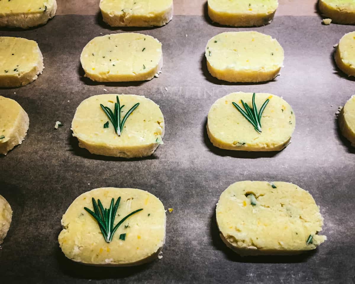 unbaked lemon rosemary shortbread cookies on a baking sheet